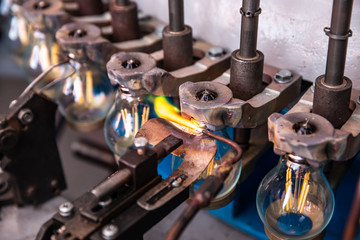 Fototapeta na wymiar Automated workshop conveyor for production of glass lamps bulbs factory
