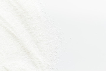 Washing powder scattered on white background top view frame copy space
