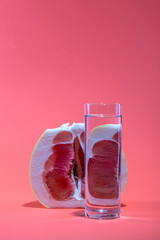 Still life with pomelo fruit and a glass of water
