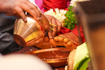 Traditional indian wedding ceremony, groom and bride hand