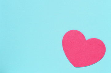 Soft pink heart on a blue background close-up. Greeting card with copy space. Flat lay minimal concept. Valentine's Day background