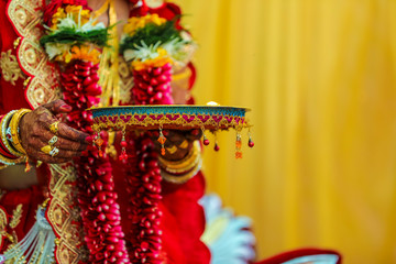Traditional indian wedding ceremony in Hinduism : Holding puja thali and oil lamp in hand