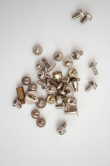 Small iron screws closeup beautifully scattered nuts