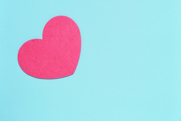 Soft pink heart on a blue background close-up. Greeting card with copy space. Flat lay minimal concept. Valentine's Day background