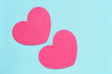 Two pink hearts on a blue background close-up. Greeting card with copy space. Flat lay minimal concept. Valentine's Day background