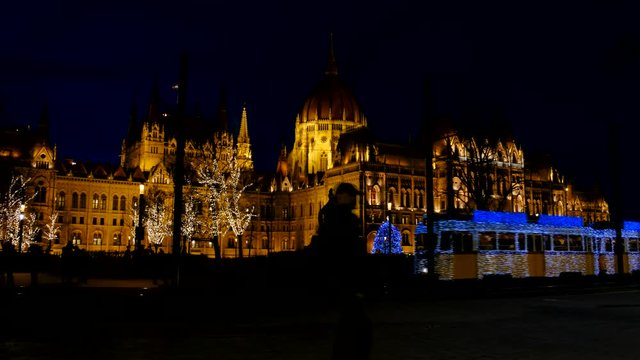 The Christmas tram runs in front of the Parliament in Budapest