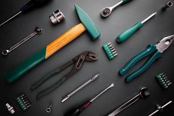 Set of tools over black background, top view with space for text