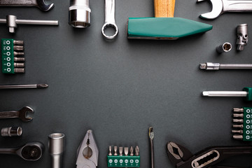 Set of tools over black background, top view with space for text