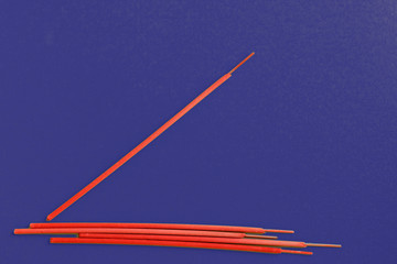 Incense aroma sticks scattered on a dark blue background