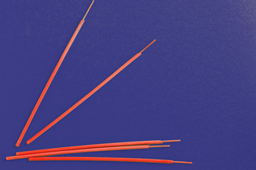 Incense aroma sticks scattered on a dark blue background