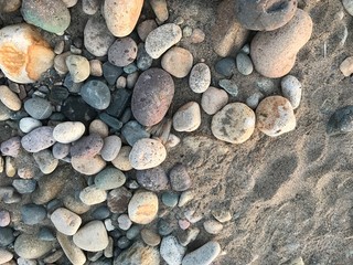 Patterns of varied stones and textures in the sand