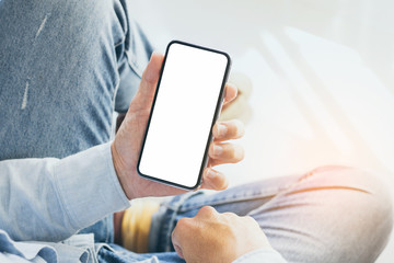 Mockup image blank white screen cell phone.men hand holding texting using mobile on desk at home office.background empty space for advertise text.people contact marketing business,technology 