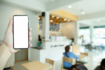 Mockup image blank white screen cell phone.men hand holding texting using mobile on desk at home office.background empty space for advertise text.people contact marketing business,technology 