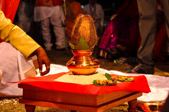 Indian wedding ceremony : decorative coper kalash with green leaf and coconut 
