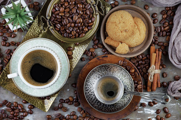 Black coffee beans roast in a pan in the smoke