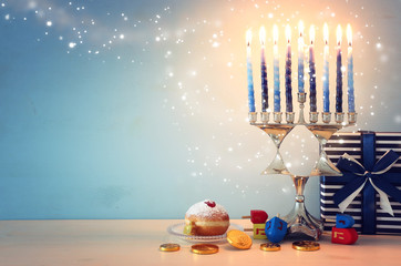 religion image of jewish holiday Hanukkah with menorah (traditional candelabra), spinning top and...