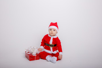 a baby in a Santa Claus costume on a white background