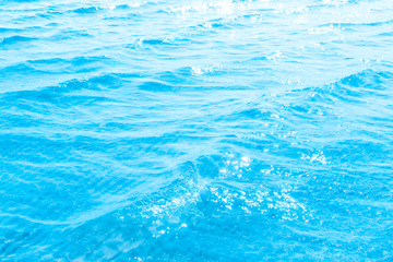 Blue transparent sea water near the beach texture background. clear water surface with slight waves...