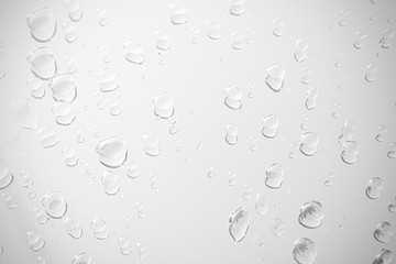 Raindrop water dew drop on glass wet white gray blue background.