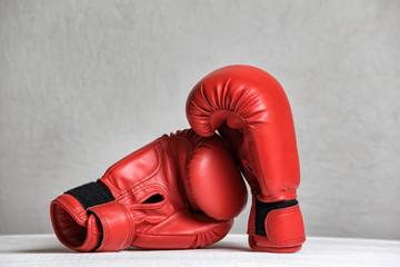 Pair of red boxing gloves on a white background. Close-up