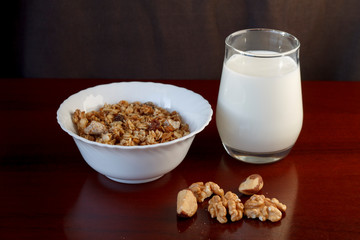 healthy Breakfast: a glass of milk, a Cup of muesli and nuts