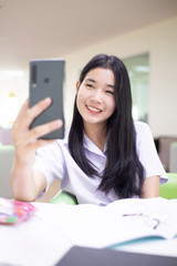 Students holding a phone to study online