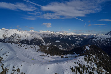 Panoramic aerial view of  Brenta Dolomites, snow on the slopes of the Alps  Madonna di Campiglio, Pinzolo, Italy. The most popular, ski resorts in Italy. Aerial photography with drone. Ski slopes