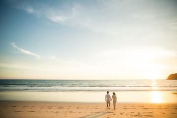 Fototapeta na wymiar Couple on the beach at sunset