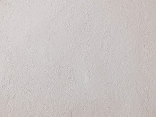 Textured grinded plaster in light beige. Background or texture seamless pattern