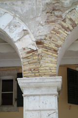 a broken facade of a column in corfu