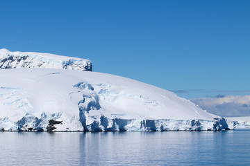 Fototapeta na wymiar The frozen coasts of an island along the coasts of the Antarctic Peninsula, Antarctica