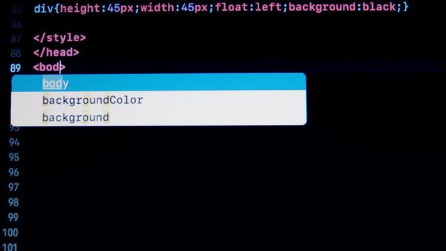 Developer type HTML 5 programming code on notebook screen