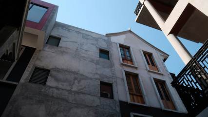 details of a modern loft construction of houses and clean blue sky, contrast of buildings.