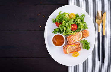 Baked salmon fillet with fresh vegetables salad. Healthy food. Ketogenic/paleo diet. Top view, copy space