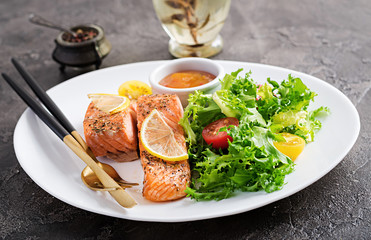 Baked salmon fillet with fresh vegetables salad. Healthy food. Ketogenic/paleo diet.