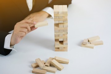 .Planning risk and strategy in businessman gambling placing wooden block.Business concept for...