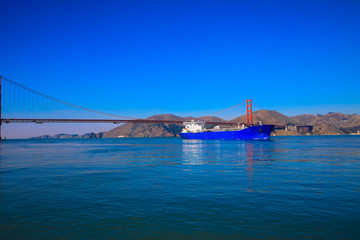 Container ship entering San Francisco Bay under Golden Gate Bridge