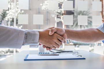 Doctors and male patients shake hands after the patient has finished treatment. Medical concepts...