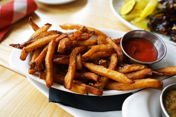Close up sweet potato fries served with dipping ketchup sauce