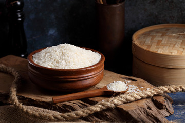 Close up white rice in measuring cup on table, Thai Jasmine rice in rustic kitchen background