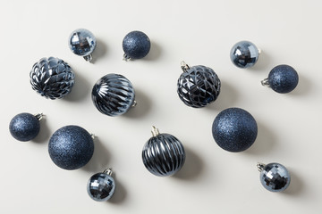 Christmas classic blue balls on pastel grey. Top view. Xmas pattern. Holiday greeting card.