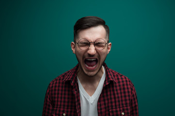 Fototapeta premium Screaming emotional young desperate man