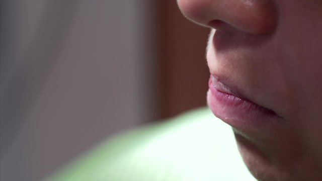Extreme close view of patient's teeth. Orthodontist is fixing the arch wire on braces