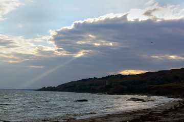 ray of light through clouds at sunset on the coast