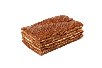 Slice of chocolate cake with milk filling and chocolate isolated on white background.