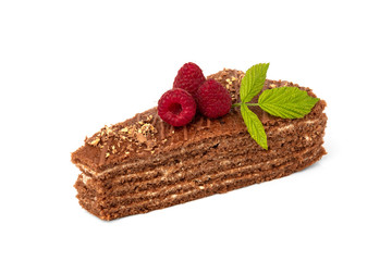 Slice of chocolate cake with milk filling and raspberry isolated on white background.
