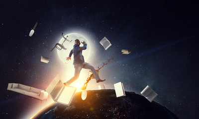 Naklejka premium Businessman jumping in gravity. Mixed media