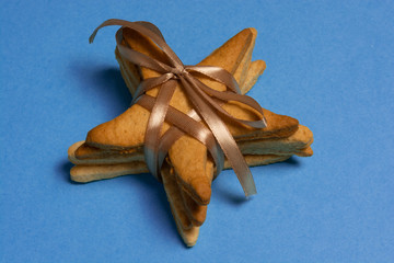 Christmas gingerbread star cookies on blue background