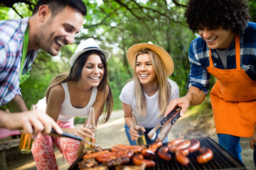 Friends having fun in nature doing bbq