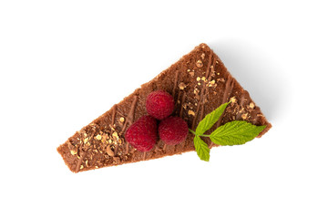 Slice of chocolate cake with milk filling and raspberry isolated on white background.